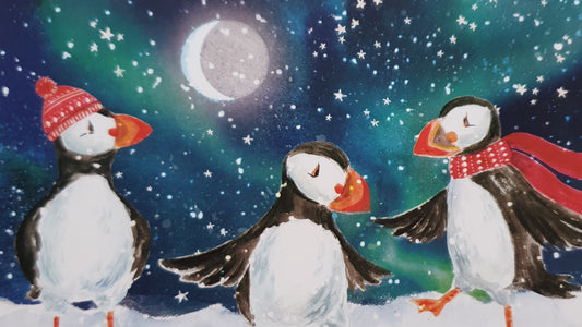 three dancing puffins wearing scarves and hats from an RSPB Christmas card by Emily Rose Dixon